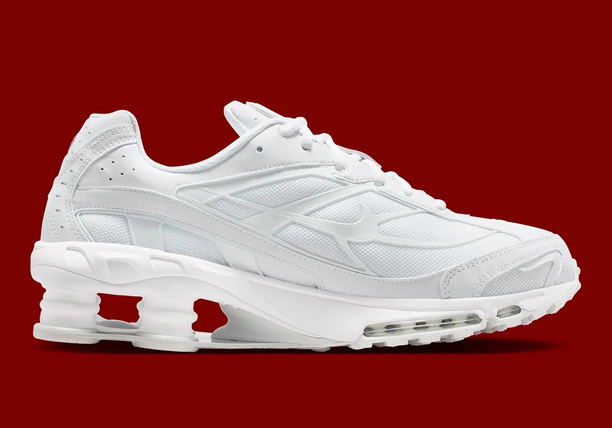 Nike Shox Ride 2 in Triple White colorway, showing full white upper, midsole, and visible Shox cushioning units - detail view 2