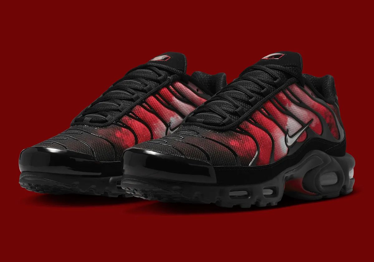 Nike Air Max Plus Flairemax in black with red flame graphic, metallic silver Swoosh, and metal lace tips - detail view 1