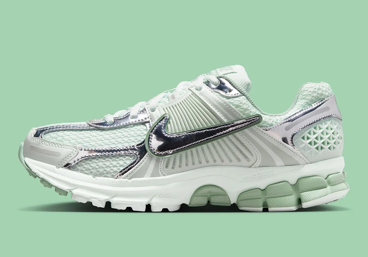 Nike Zoom Vomero 5 in Barely Green with metallic silver chrome accents and dual Swoosh detail - detail view 1