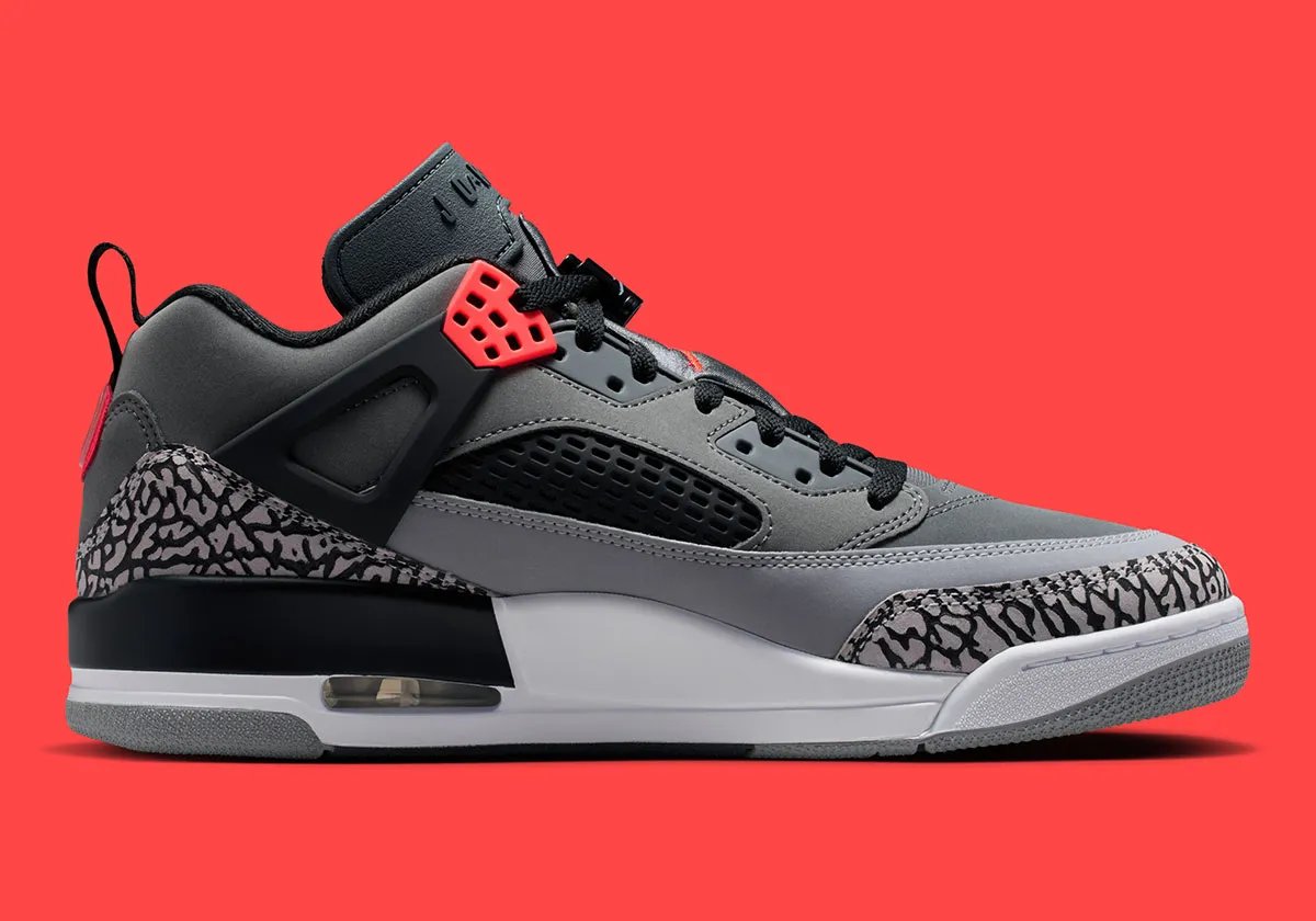 Jordan Spiz'ike Low in Infrared colorway, side profile view showing mixed-material upper construction and distinctive lace toggle detail - detail view 3