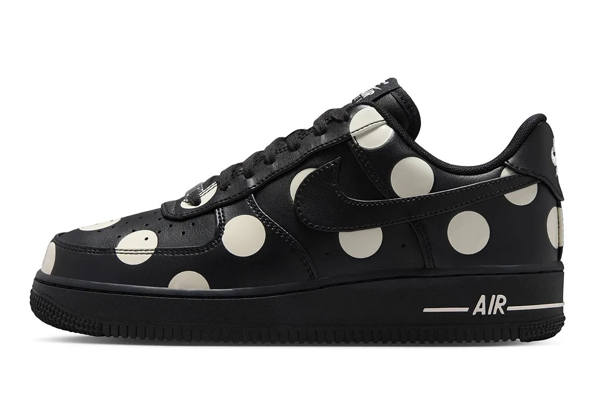 Nike Air Force 1 Low in black leather with cream polka dots, women's colorway, overhead view showing dot pattern across upper - detail view 1
