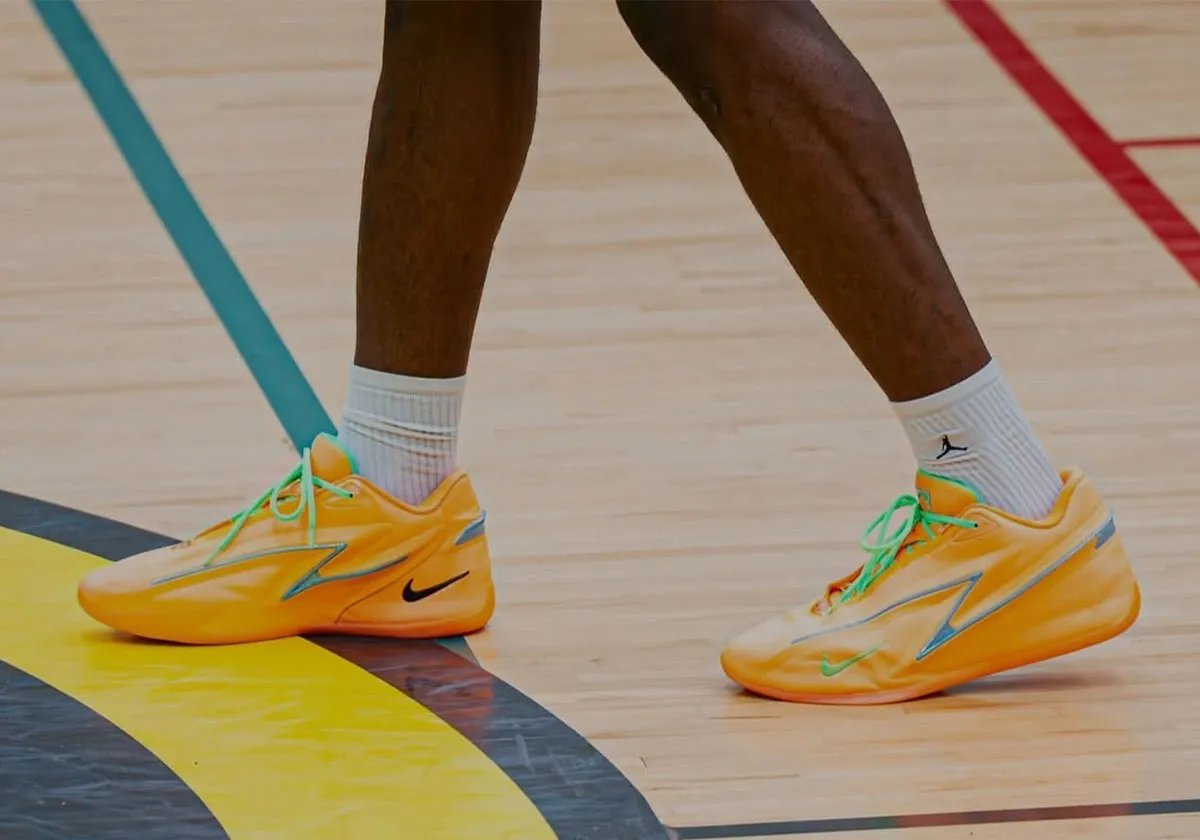Nike KD 19 EYBL Peach Jam colorway featuring pale orange base with steely blue Z-shaped overlays and neon green accents - detail view 1