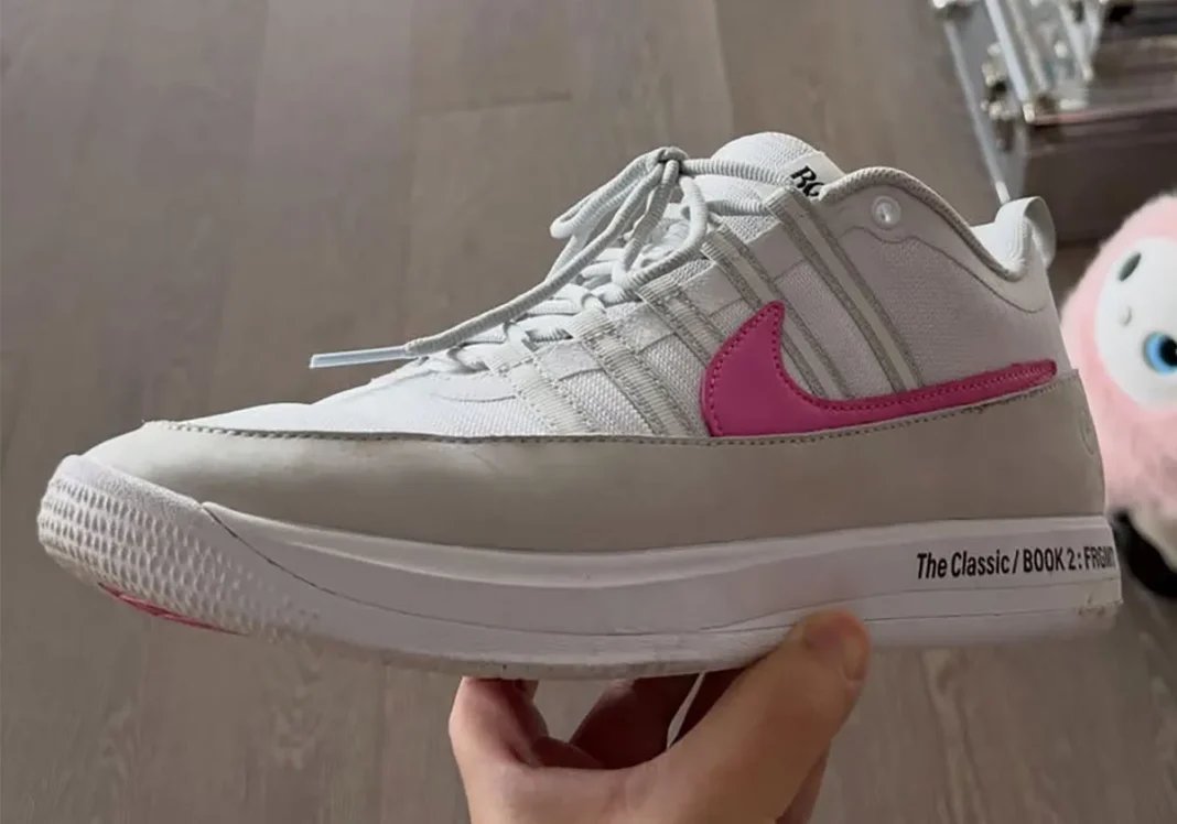 Fragment Design x Nike Book 2 in white with light tan accents and pink Swoosh, midsole detail showing black "The Classic: BOOK 2: Fragment" text