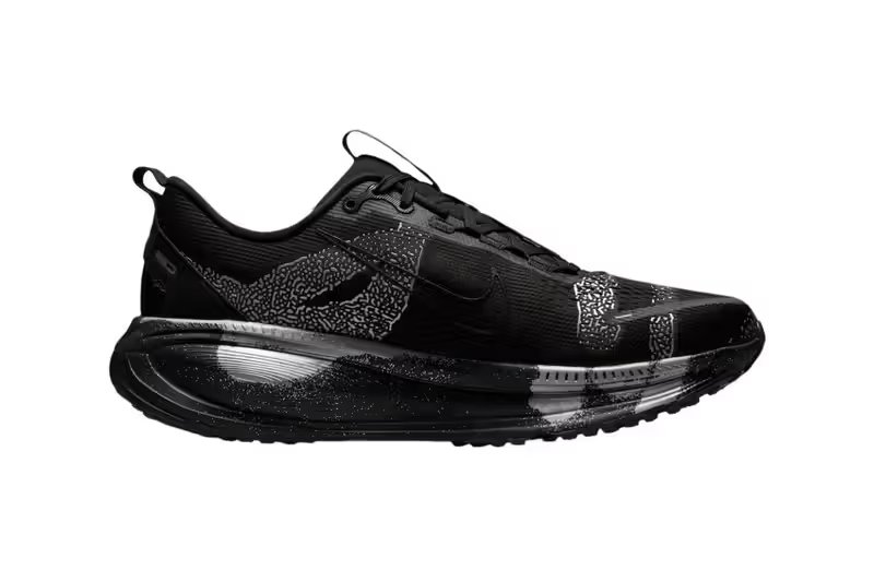 Nike Vomero 18 DSRPT in Iron Grey, Light Smoke Grey, and Black colorway showing abstract two-tone design on running shoe upper - detail view 3