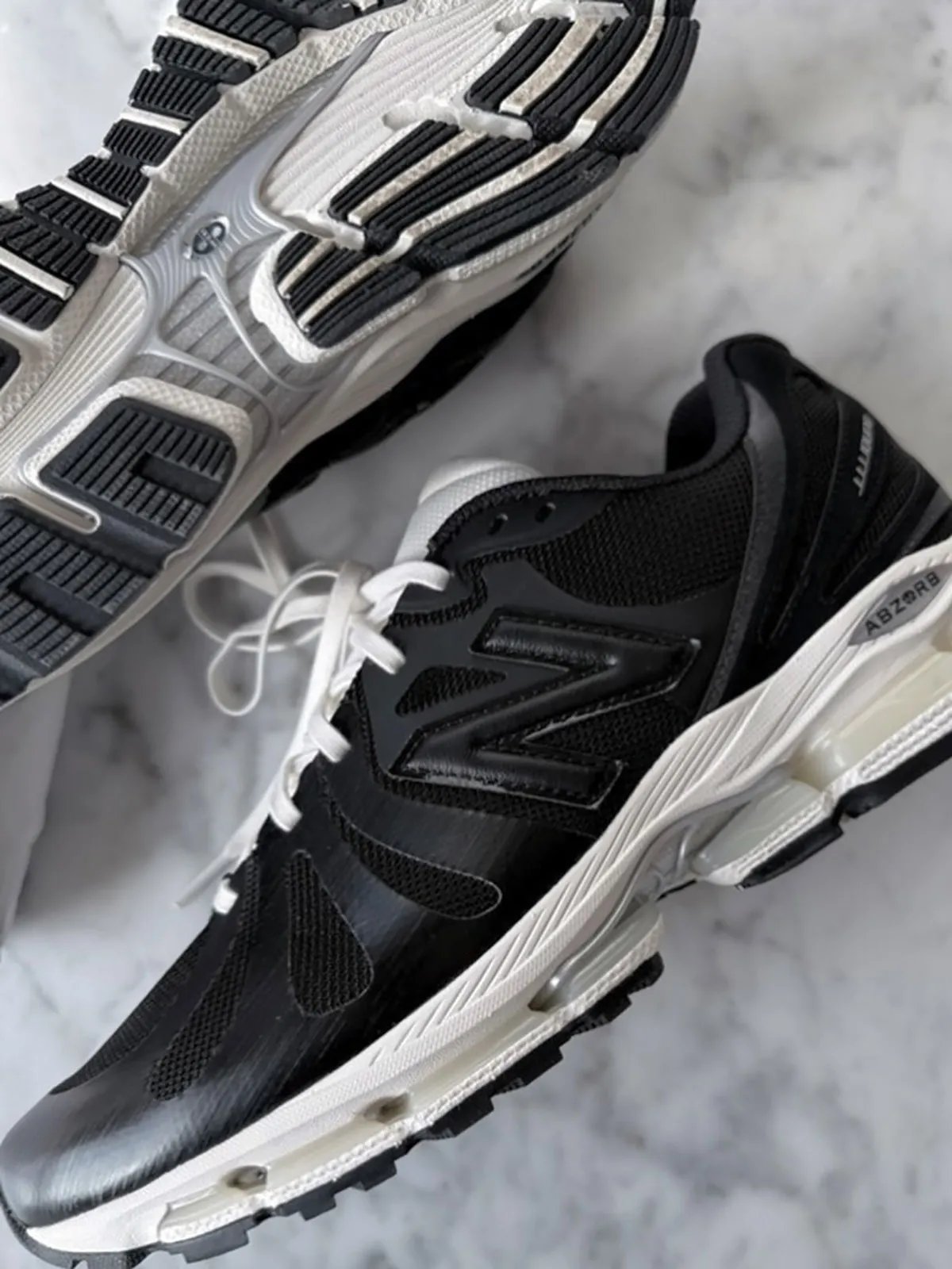 JJJJound x New Balance 1890 collaboration sneaker in black with aged off-white midsole and silver ABZORB detailing - detail view 1