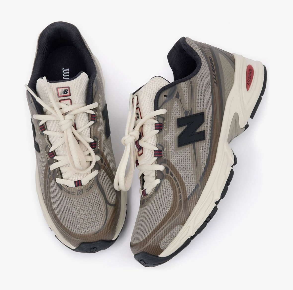 JJJJound x New Balance 740N in Mushroom colorway, featuring no-sew construction with beige, taupe, and off-white upper, navy eyelets, and red accents - detail view 3