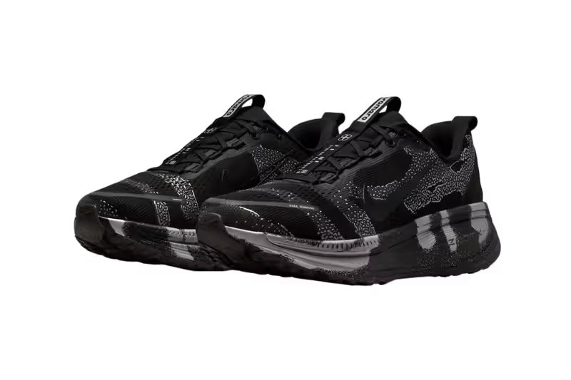 Nike Vomero 18 DSRPT in Iron Grey, Light Smoke Grey, and Black colorway showing abstract two-tone design on running shoe upper - detail view 4