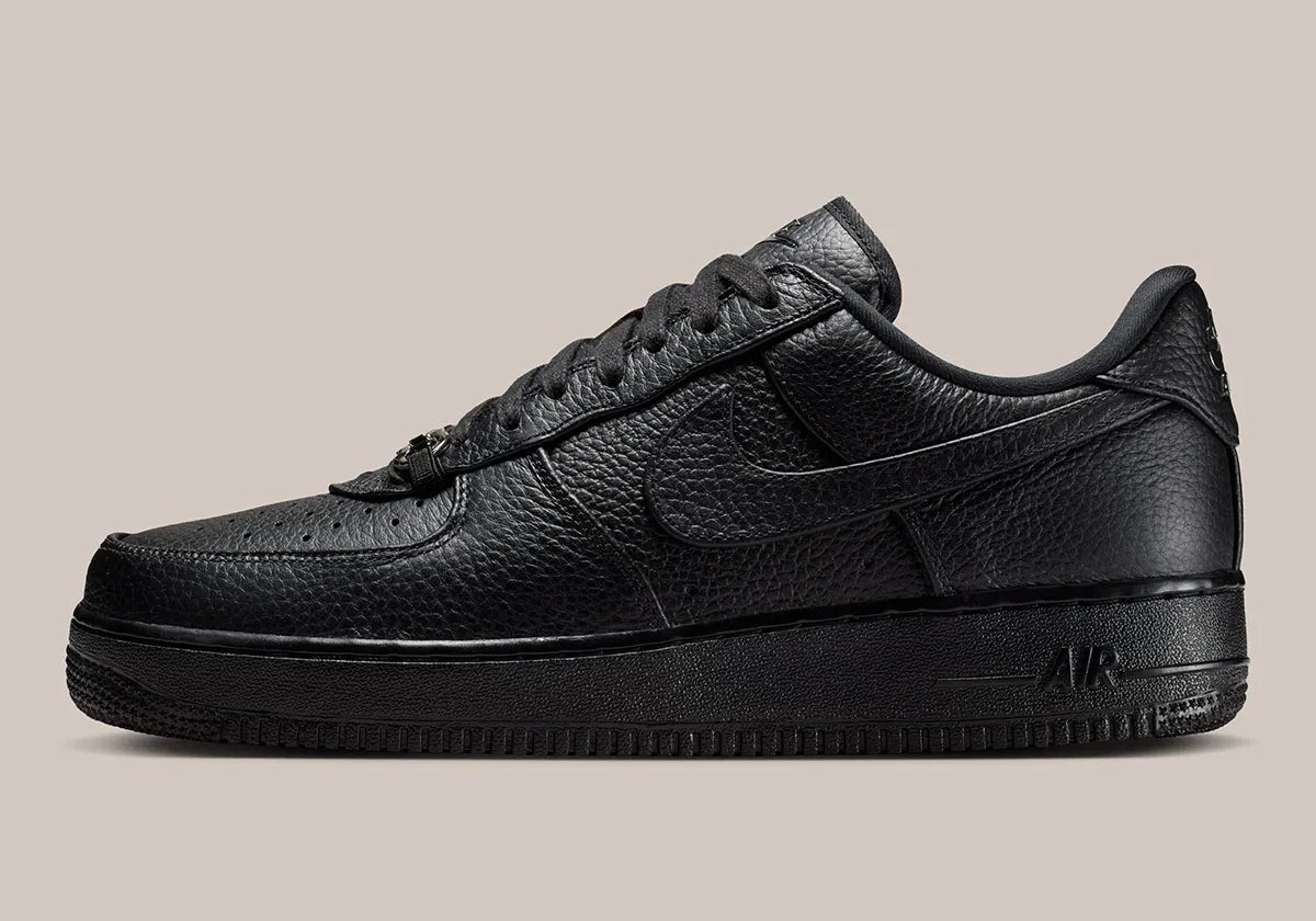 Nike Air Force 1 Low in black pebbled leather featuring silver loafer buckle accent at lace collar - detail view 1