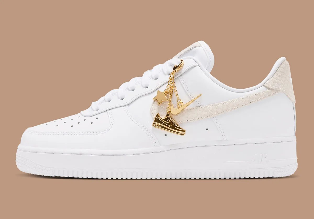 Women's Nike Air Force 1 Low in white leather with tan snakeskin Swoosh and detachable golden charm accessories - detail view 1