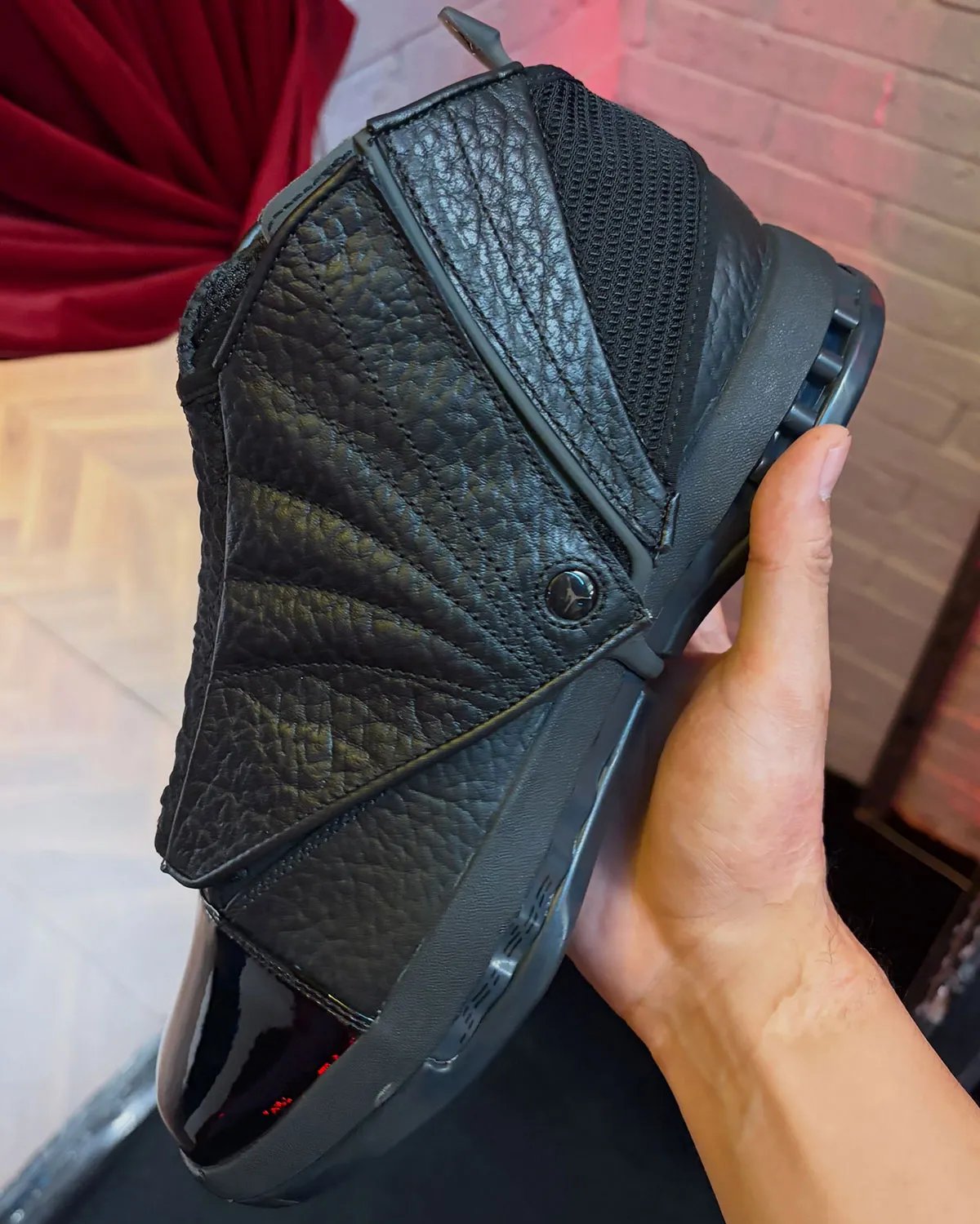 Air Jordan 16 Black Pack featuring full-grain pebbled leather upper and glossy patent leather toe box in all-black colorway