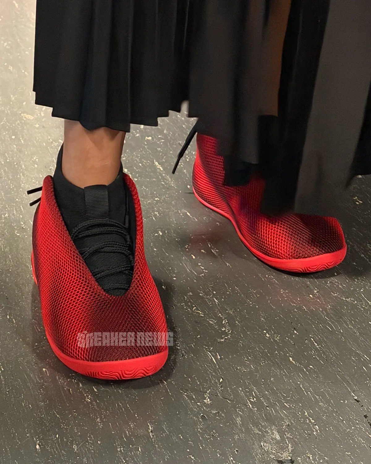 Jordan Vail lifestyle sneaker in red and black, showcasing mesh upper and unconventional rear-wrapping lace system - detail view 1