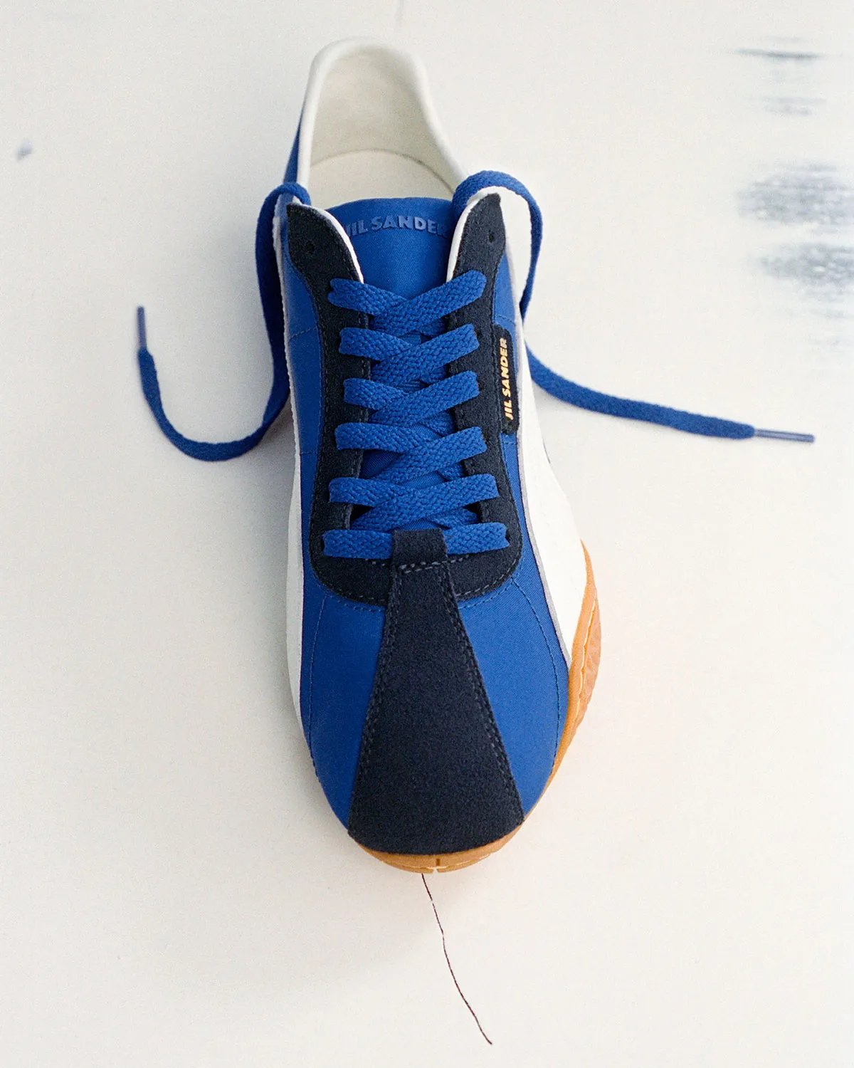 PUMA x Jil Sander K-Street sneaker in blue and navy colorway, showing low-profile sole and layered panel construction - detail view 5