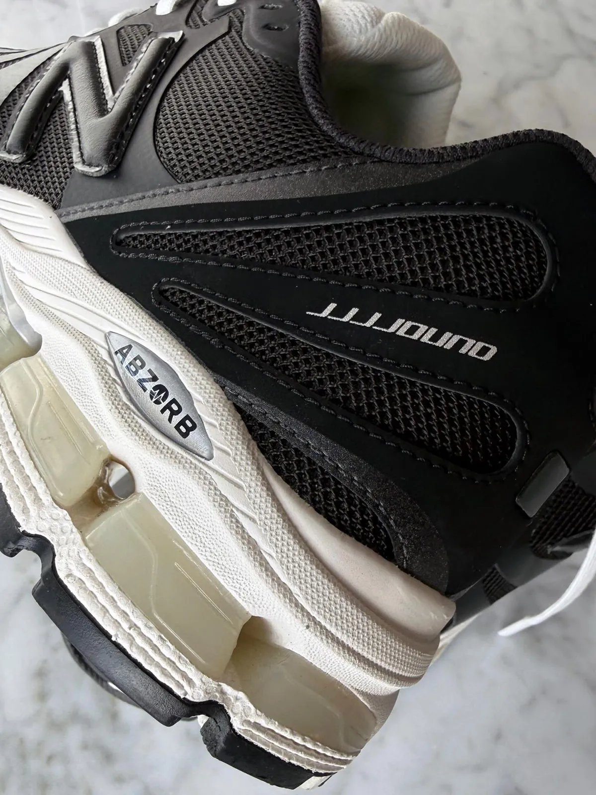 JJJJound x New Balance 1890 collaboration sneaker in black with aged off-white midsole and silver ABZORB detailing - detail view 2