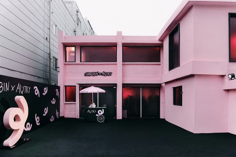 Autry x Changbin capsule collection launch event in Seoul featuring pink-themed venue with reimagined Medalist and Hyperway sneakers displayed on elevated platforms