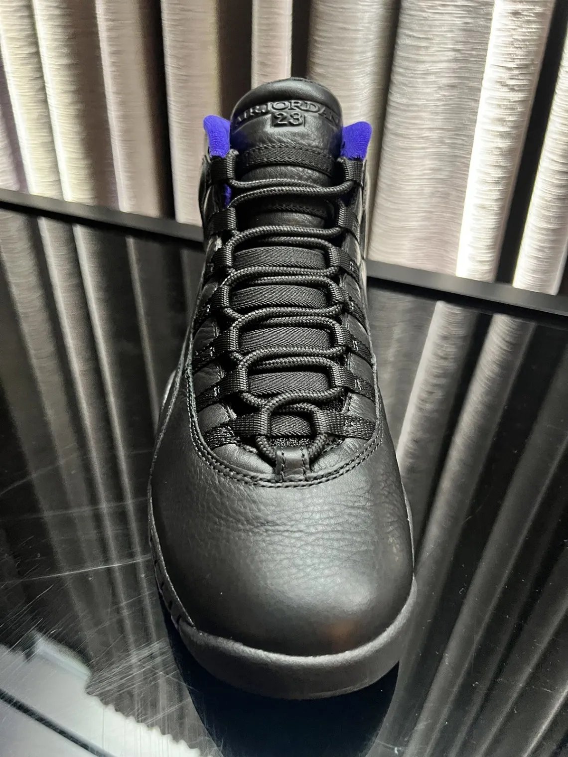 Air Jordan 10 OG Sacramento in black leather with dark concord purple accents, shown from multiple angles during 2026 release preview - detail view 4