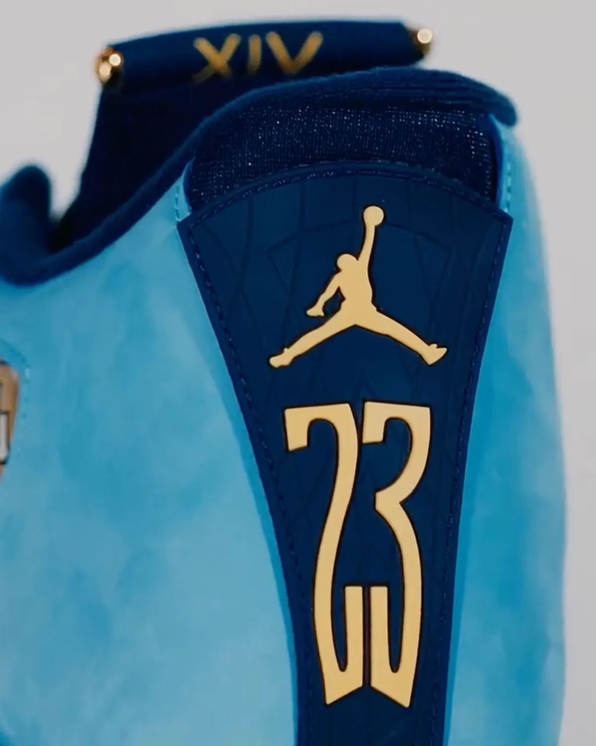 Marquette Air Jordan 14 PE in monochromatic suede with gold midsole vents and carbon fiber overlays - detail view 2