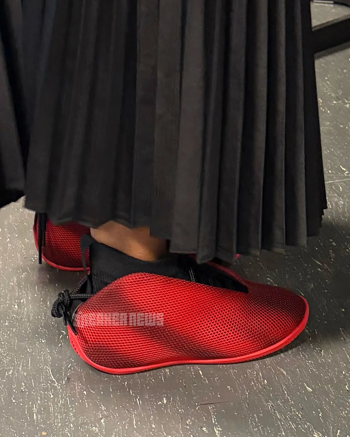 Jordan Vail lifestyle sneaker in red and black, showcasing mesh upper and unconventional rear-wrapping lace system