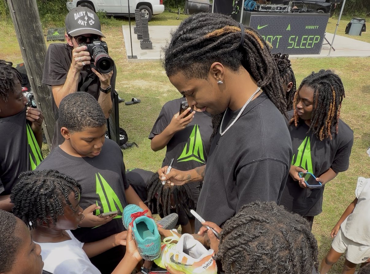 Ja Morant and his daughter Kaari unveil a Nike Ja logo at Crestwood High School during the Nike Ja 4 Dark Mode and Ja Twelve Time launch weekend in Sumter, South Carolina