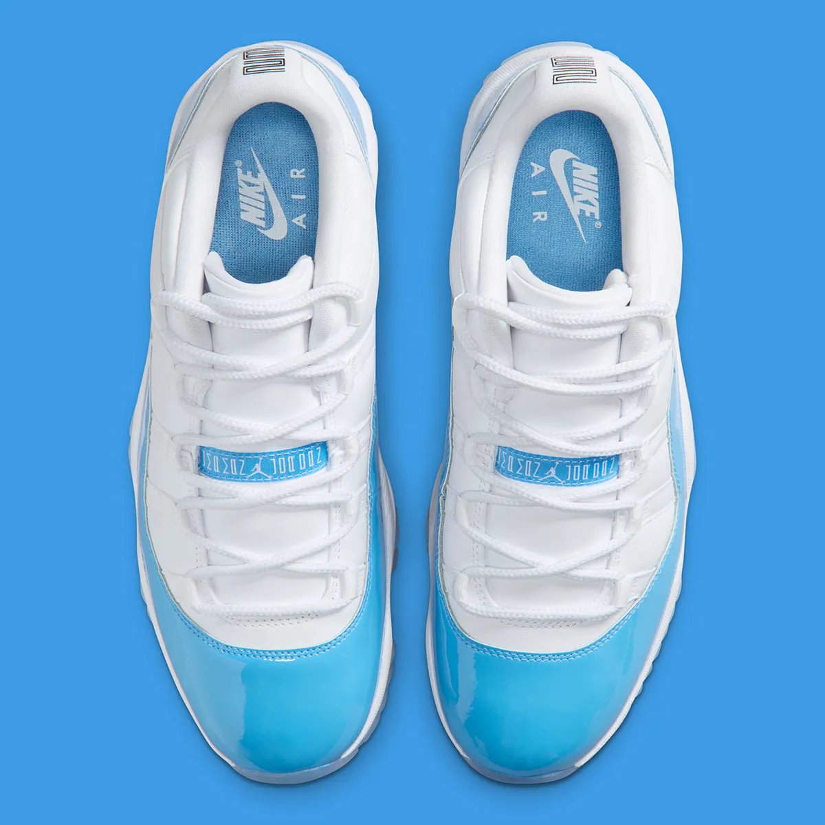 Air Jordan 11 Low in University Blue and white, showing mudguard detail and icy translucent sole - detail view 3