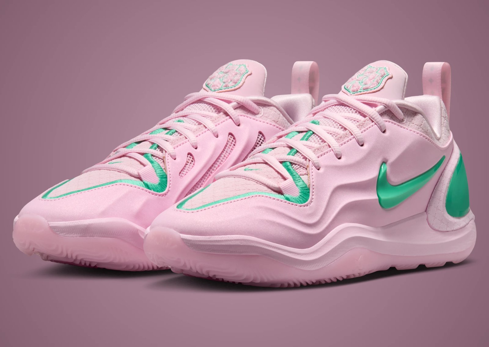 Nike A'Two Pinkies Up in pink and green Alpha Kappa Alpha colors, shown from side angle with embroidered toebox border and green Swoosh detail - detail view 1