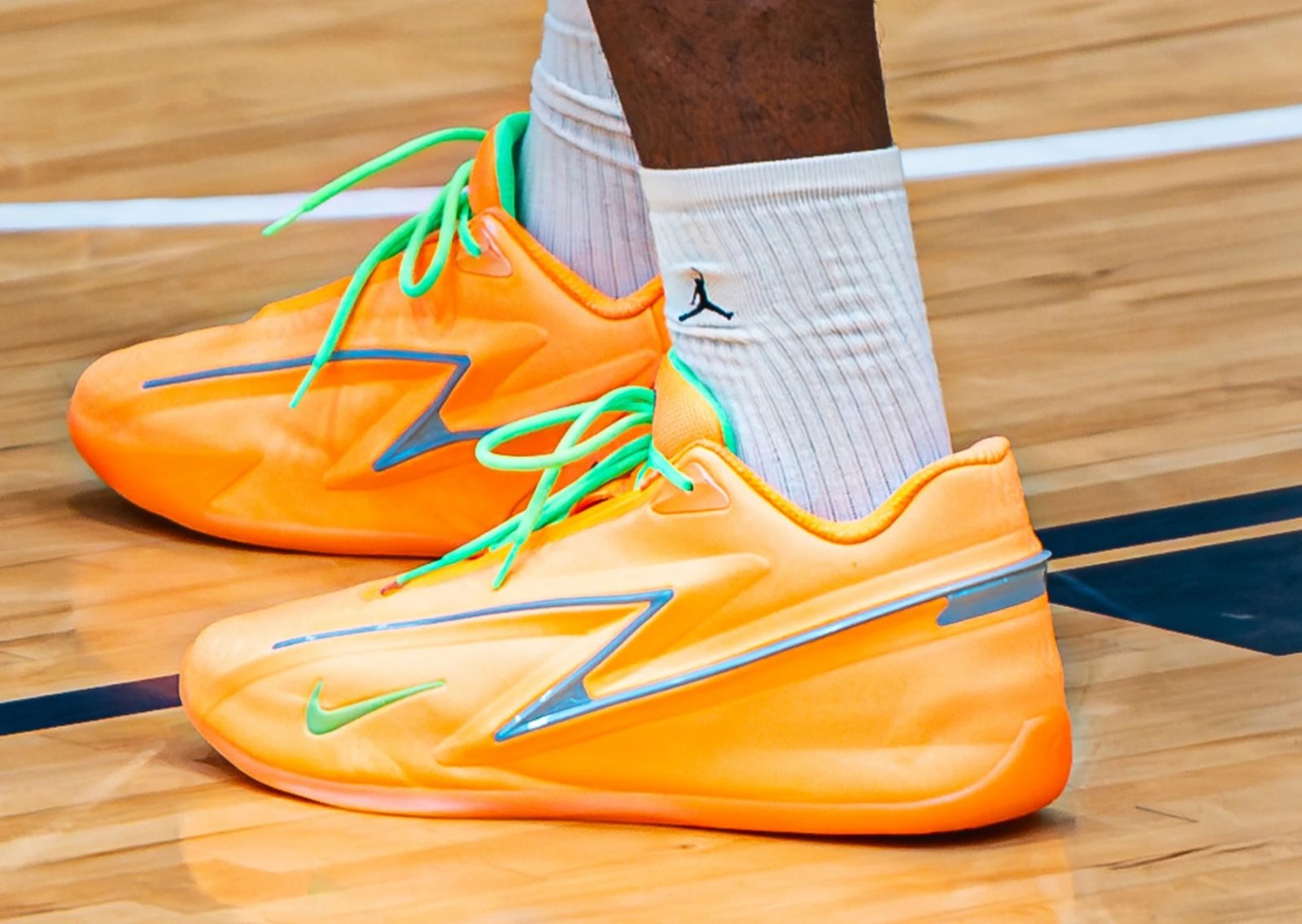 Nike KD 19 EYBL Peach Jam PE in bright orange with green peach stem accents and steel blue stabilization panels - detail view 1