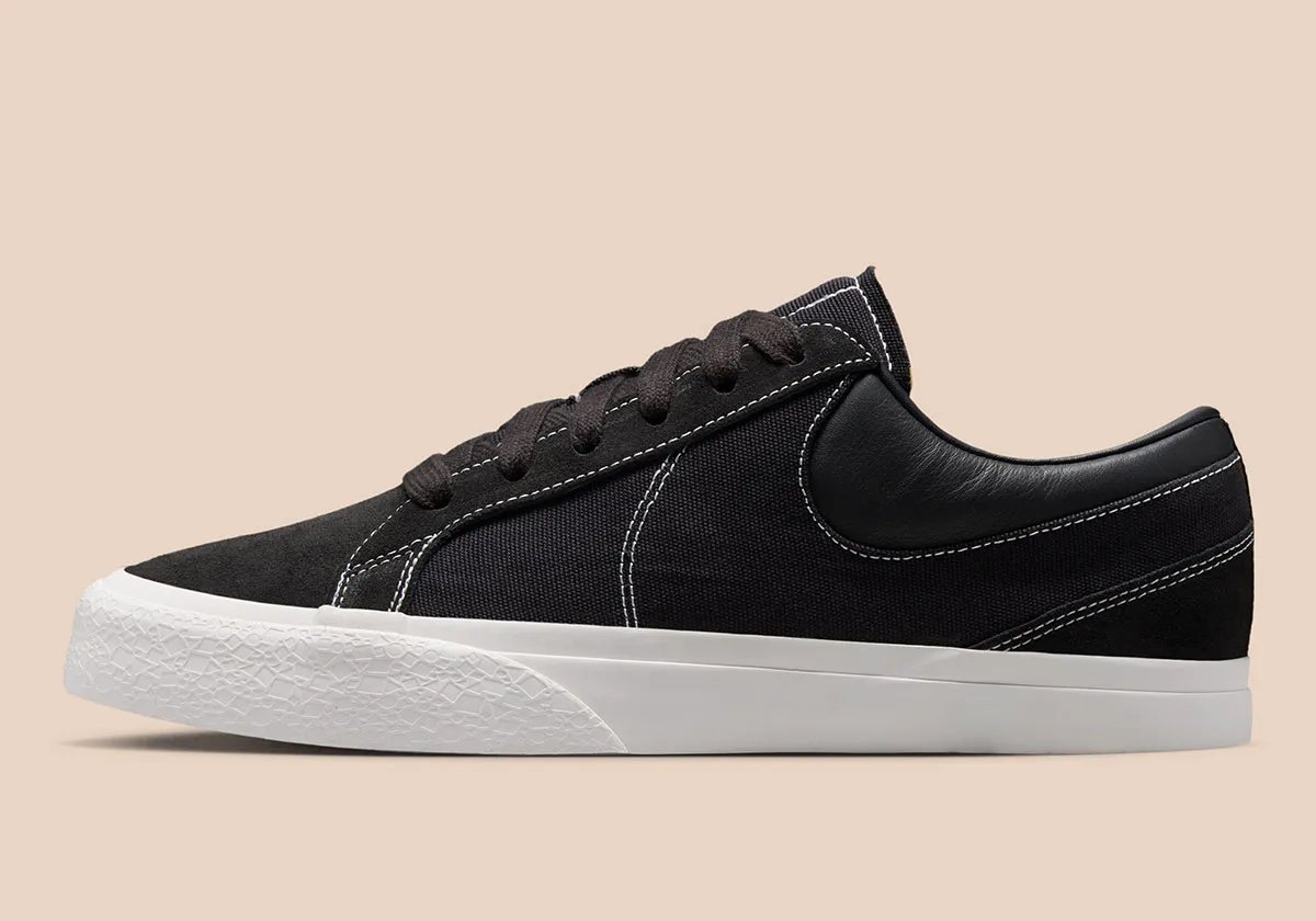 Nike Blazy in Sail colorway, showing exaggerated heel drag and curved Swoosh stitching detail on canvas panels - detail view 1