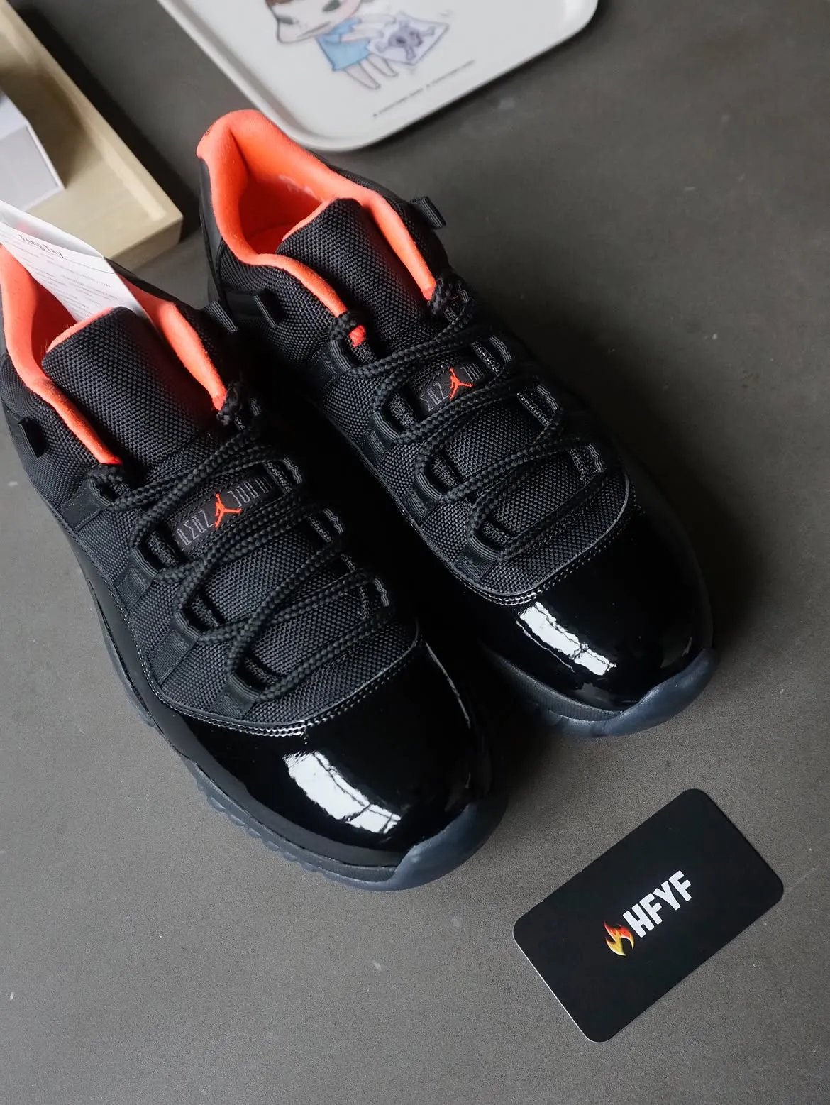 Air Jordan 11 Low Black Infrared sample featuring all-black patent leather upper with infrared sockliner and Jumpman branding - detail view 4