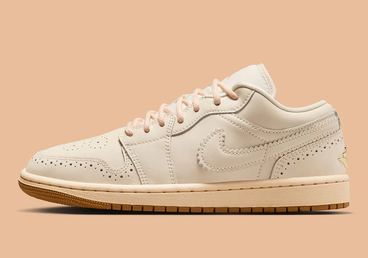 Air Jordan 1 Low in Brogue colorway featuring off-white leather with gold embroidery and rope laces - detail view 1