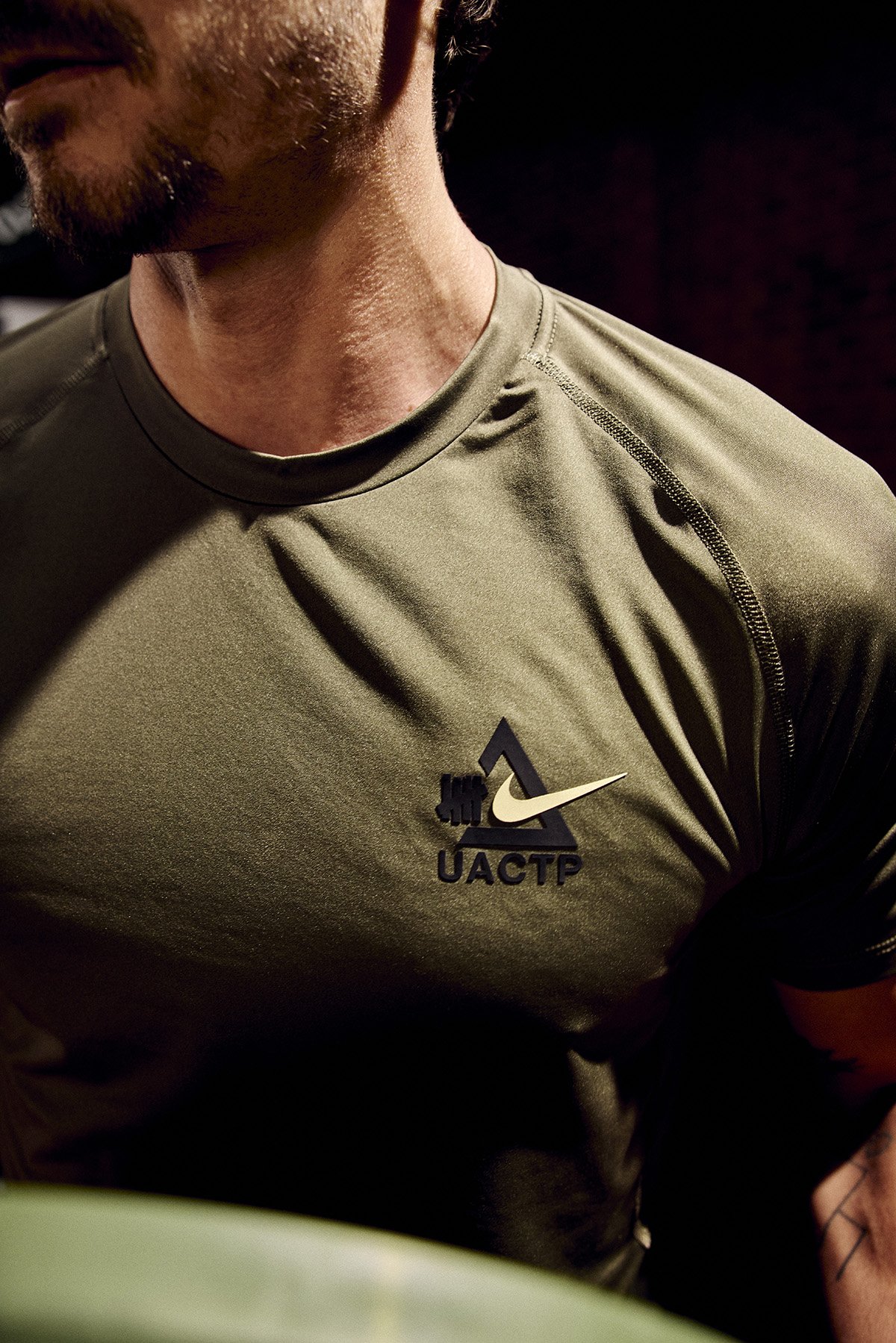 UNDEFEATED x Nike Athletic Club performance apparel collection featuring technical training pieces in minimal colorways - detail view 4