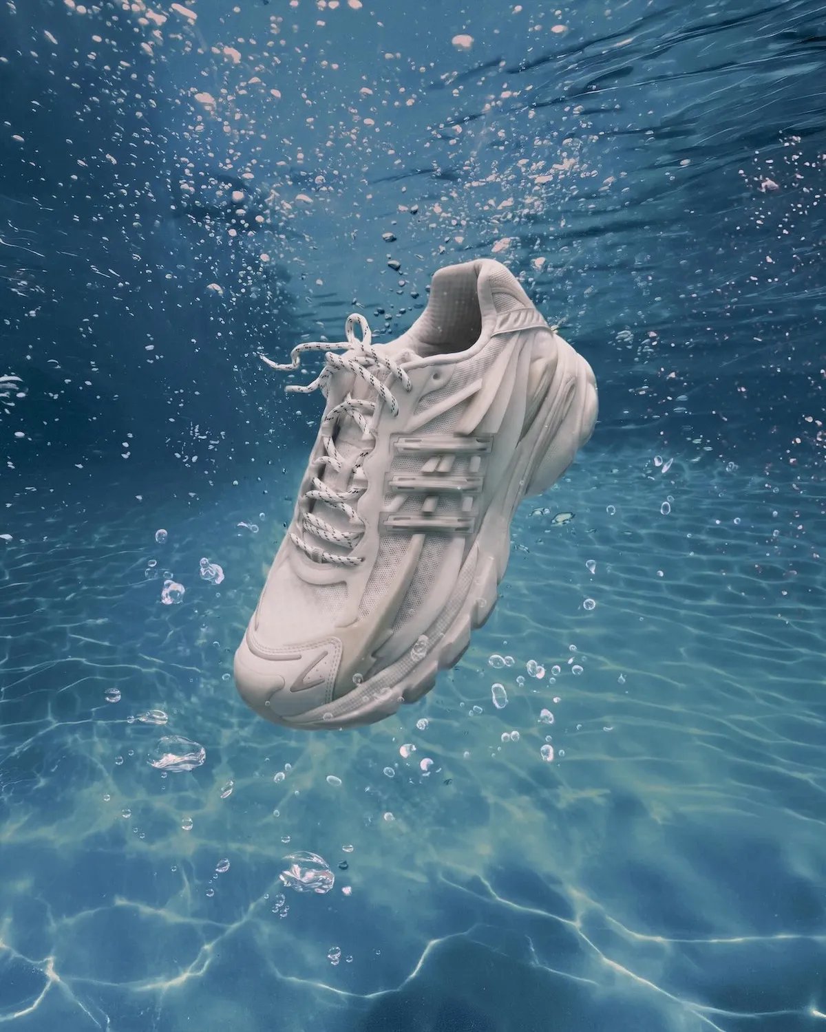 Pharrell x adidas Adistar Jellyfish Triple White featuring all-white mesh upper, molded cage overlay, and curved midsole - detail view 2