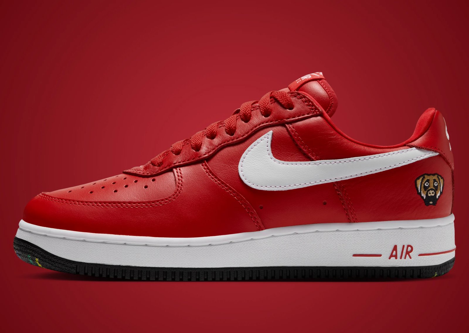 Victor Victor x Nike Air Force 1 Low '01 in Yellow and University Red, featuring monochrome plush leather with white Swoosh and custom dog head logo on lateral heel - detail view 2