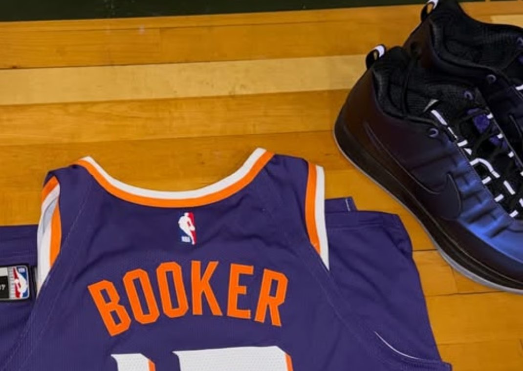Devin Booker previewing the Nike Book 2 Eggplant Foam in metallic purple with black Swoosh and 3M reflective accents - detail view 1