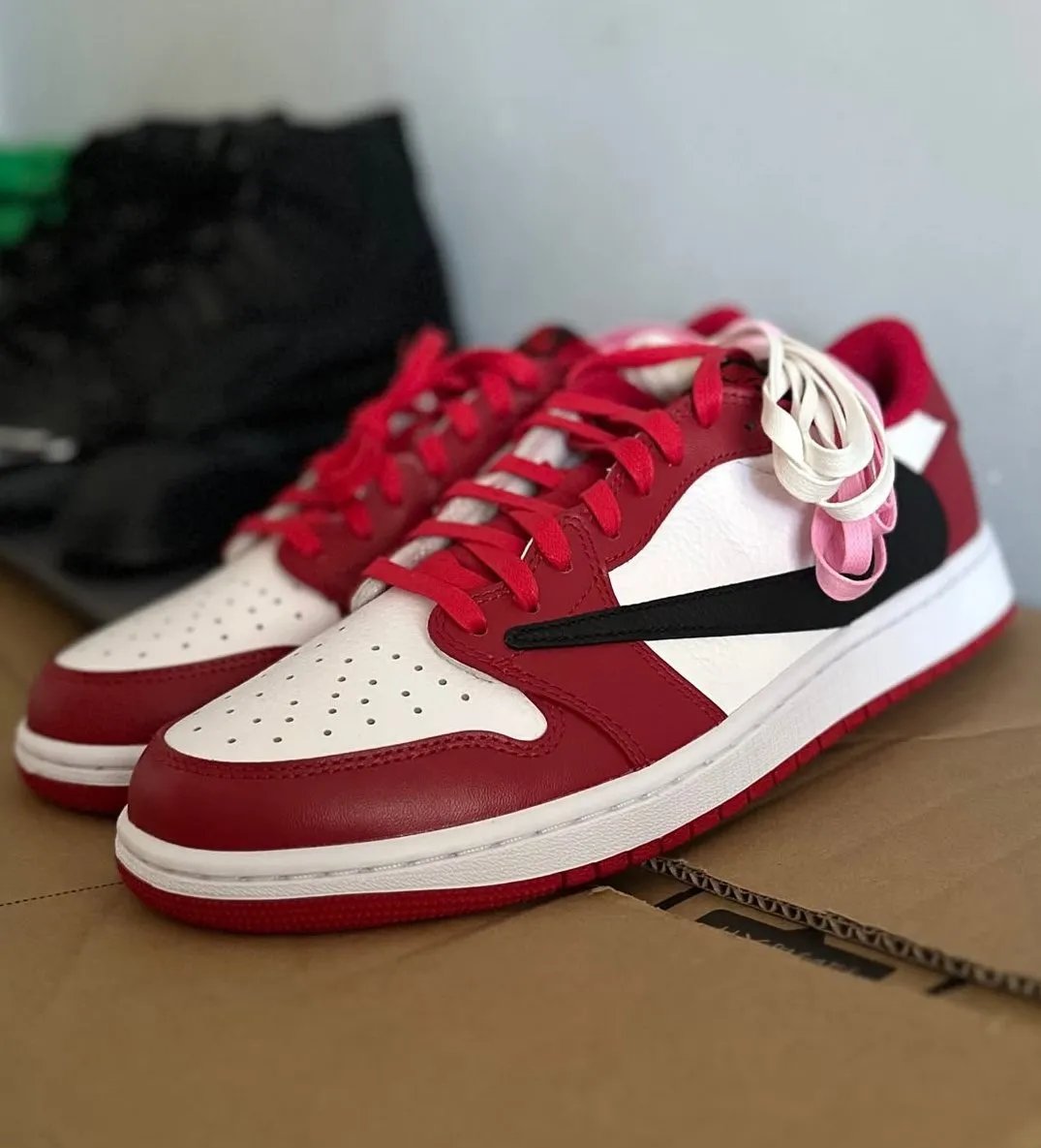 Travis Scott x Air Jordan 1 Low in white, deep red, and black Chicago-inspired colorway, lateral and medial views - detail view 2