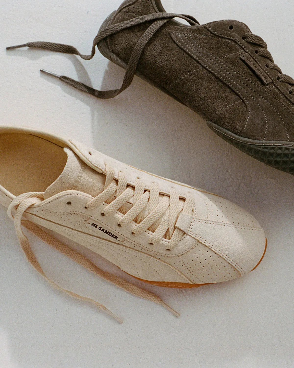PUMA x Jil Sander K-Street sneaker in blue and navy colorway, showing low-profile sole and layered panel construction - detail view 1