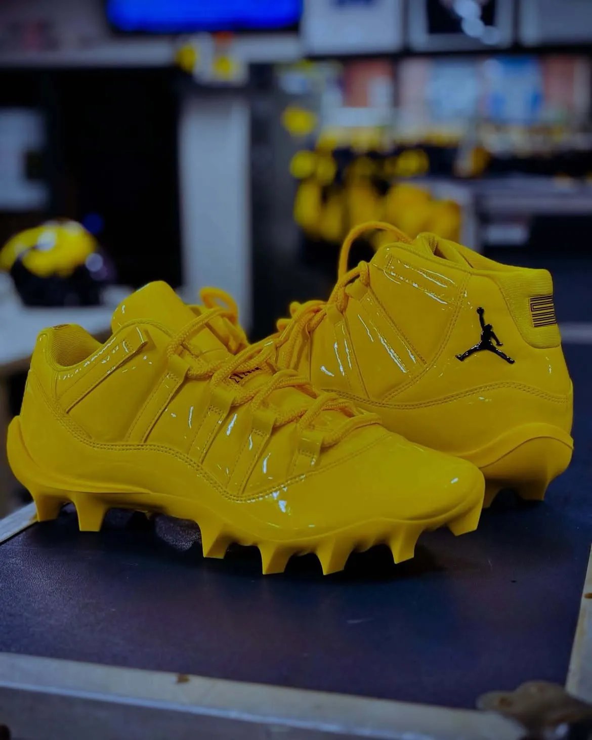 Michigan Air Jordan 11 cleat in maize yellow with black heel and ankle detailing, player-exclusive PE for Wolverines football - detail view 2