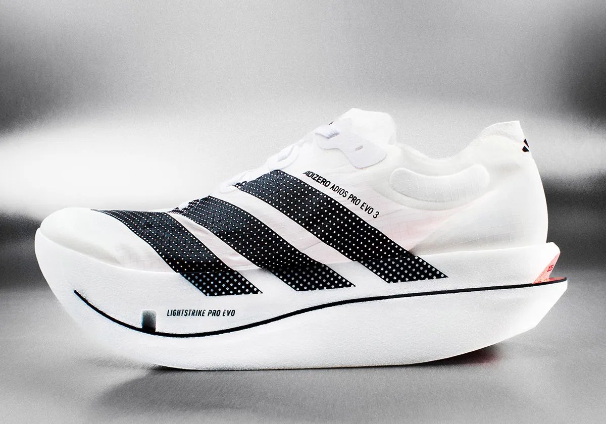 adidas Adizero Adios Pro EVO 3 running shoe in white and grey colorway, side profile view showing lightweight construction - detail view 1
