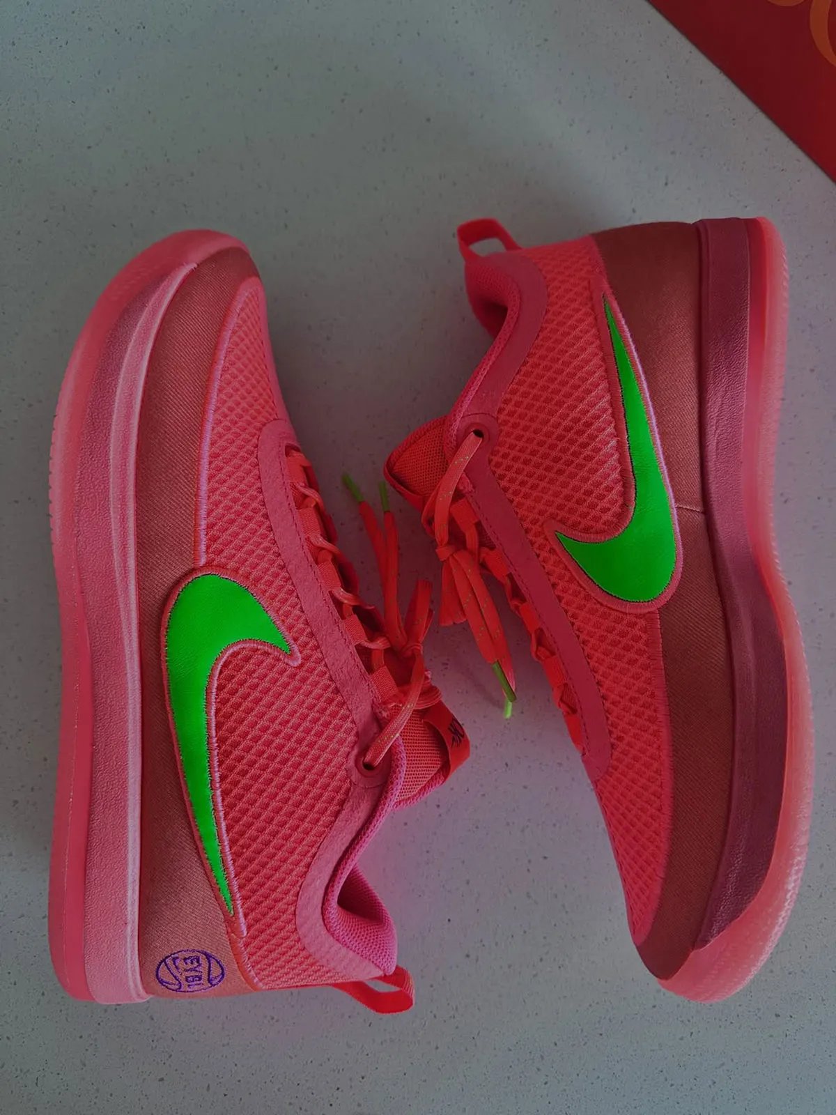 Nike Book 2 EYBL PE in pink and green colorway with chain-link mesh upper and purple accents - detail view 3