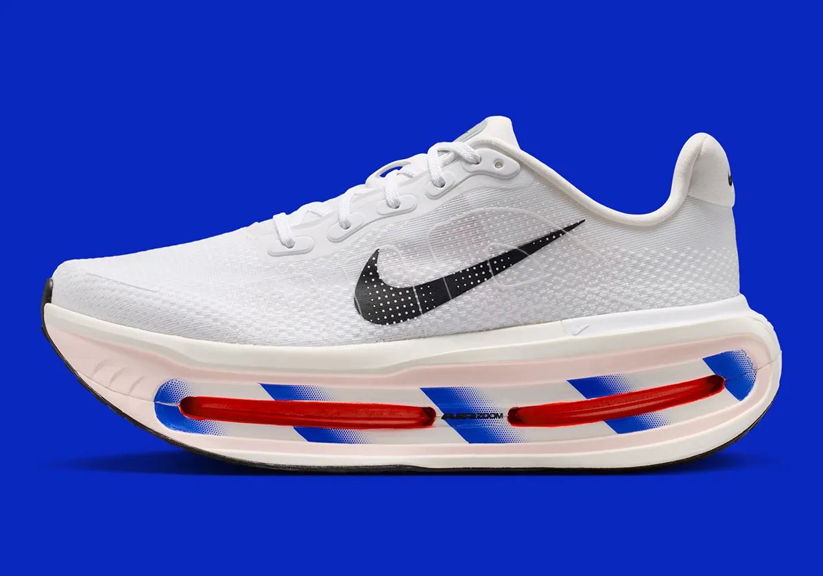Nike running collection in white with royal blue diagonal midsole striping across Zoom Air units - detail view 1