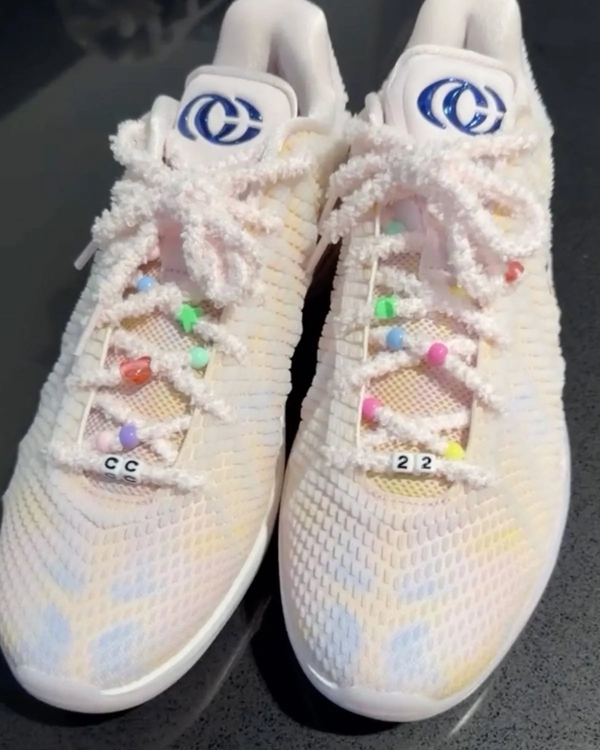 Nike Caitlin 1 'Friendship Bracelet' in Pearl Pink and Racer Blue with iridescent upper and charm-adorned laces, inspired by Taylor Swift's Eras Tour aesthetic - detail view 4