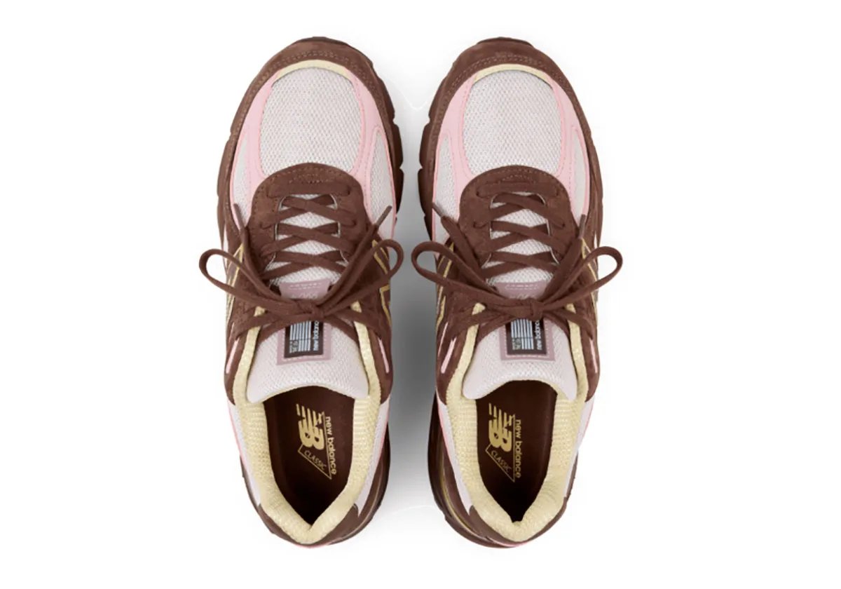 New Balance 990v4 Pumpernickel colorway featuring brown suede upper with pink mesh and yellow N logo trim - detail view 1