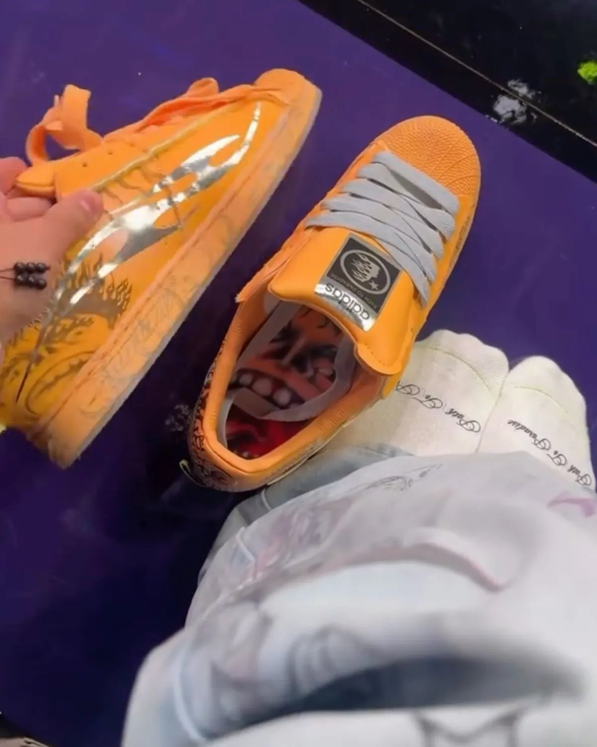 Hellstar x adidas Superstar in orange colorway, featuring the classic shell toe and three-stripe branding - detail view 4