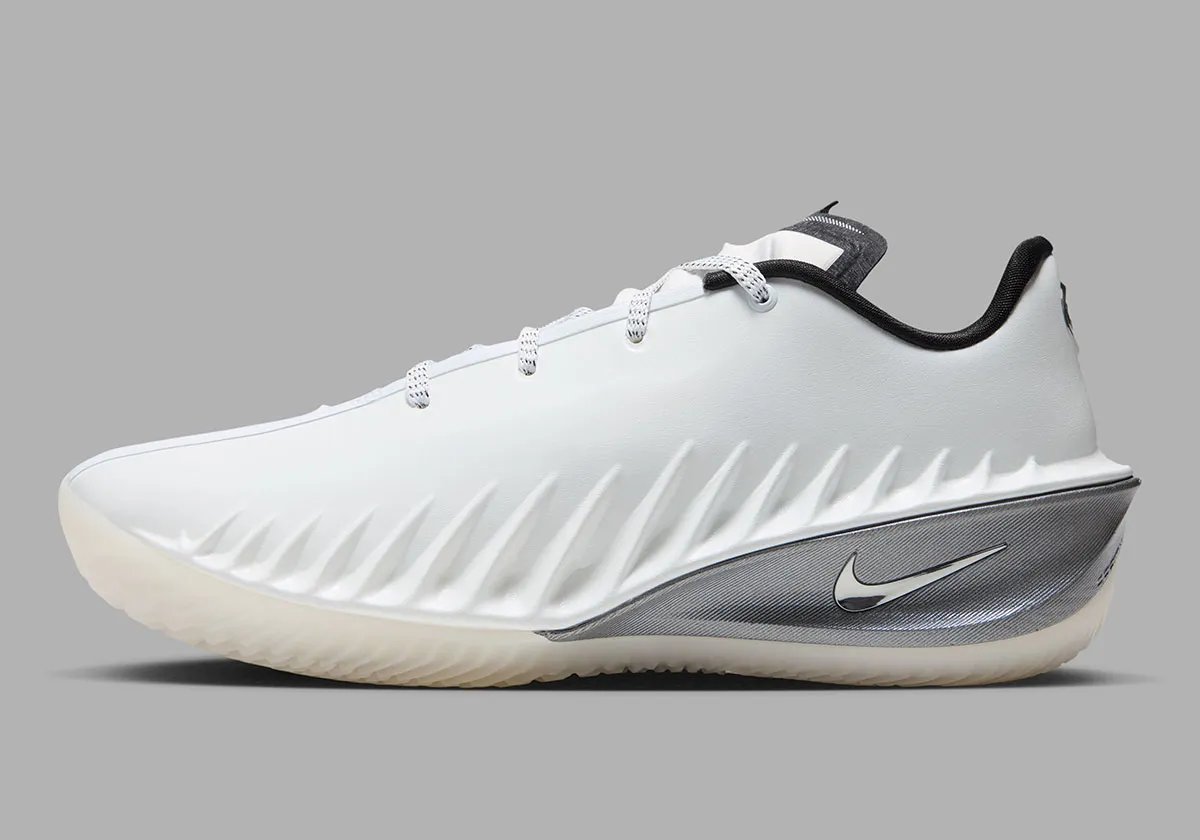 Nike GT Cut 4 SE in Summit White colorway featuring white synthetic upper, black interior, brushed metallic silver heel, and semi-translucent outsole - detail view 1