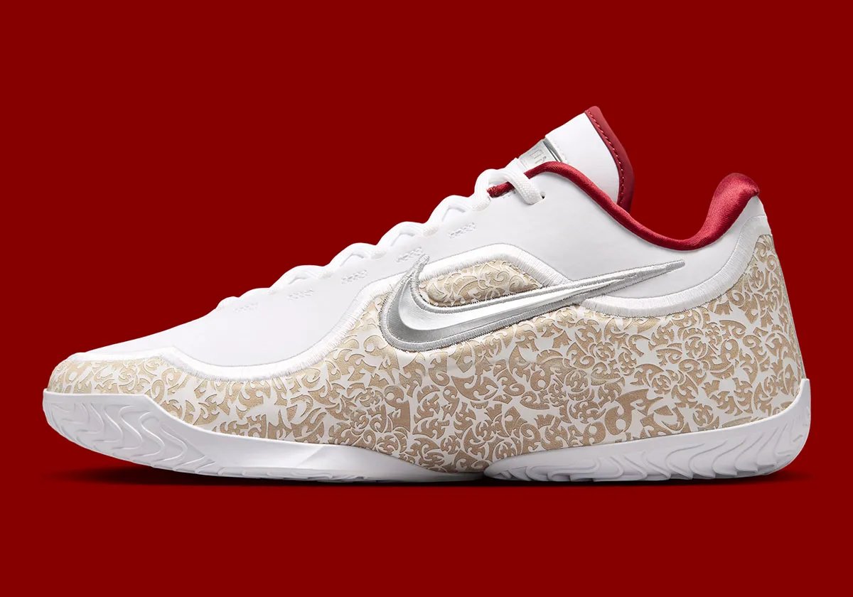 Nike LeBron 23 'Laser' colorway with white upper, laser-etched crown shell, and red satin interior lining - detail view 1