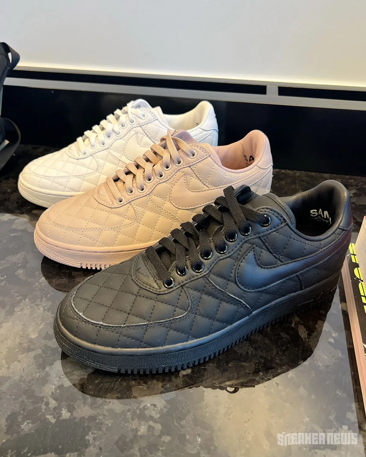Nike Air Force 1 Low Quilted in triple white, featuring crosstitch detailing across the upper and matte leather collar