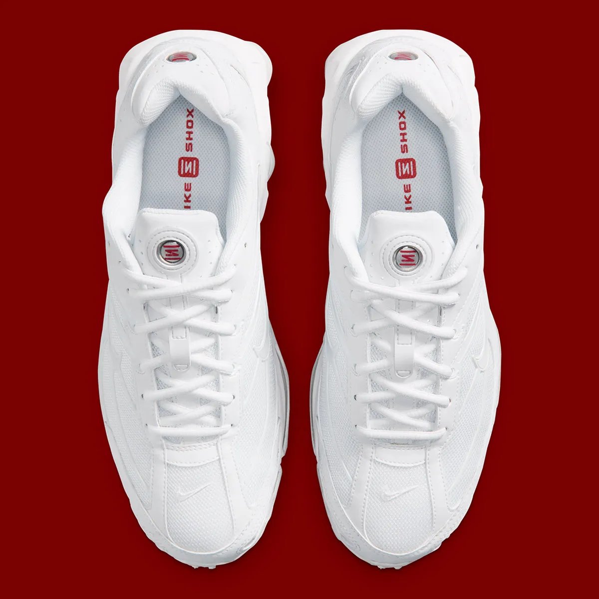 Nike Shox Ride 2 in Triple White colorway, showing full white upper, midsole, and visible Shox cushioning units - detail view 3