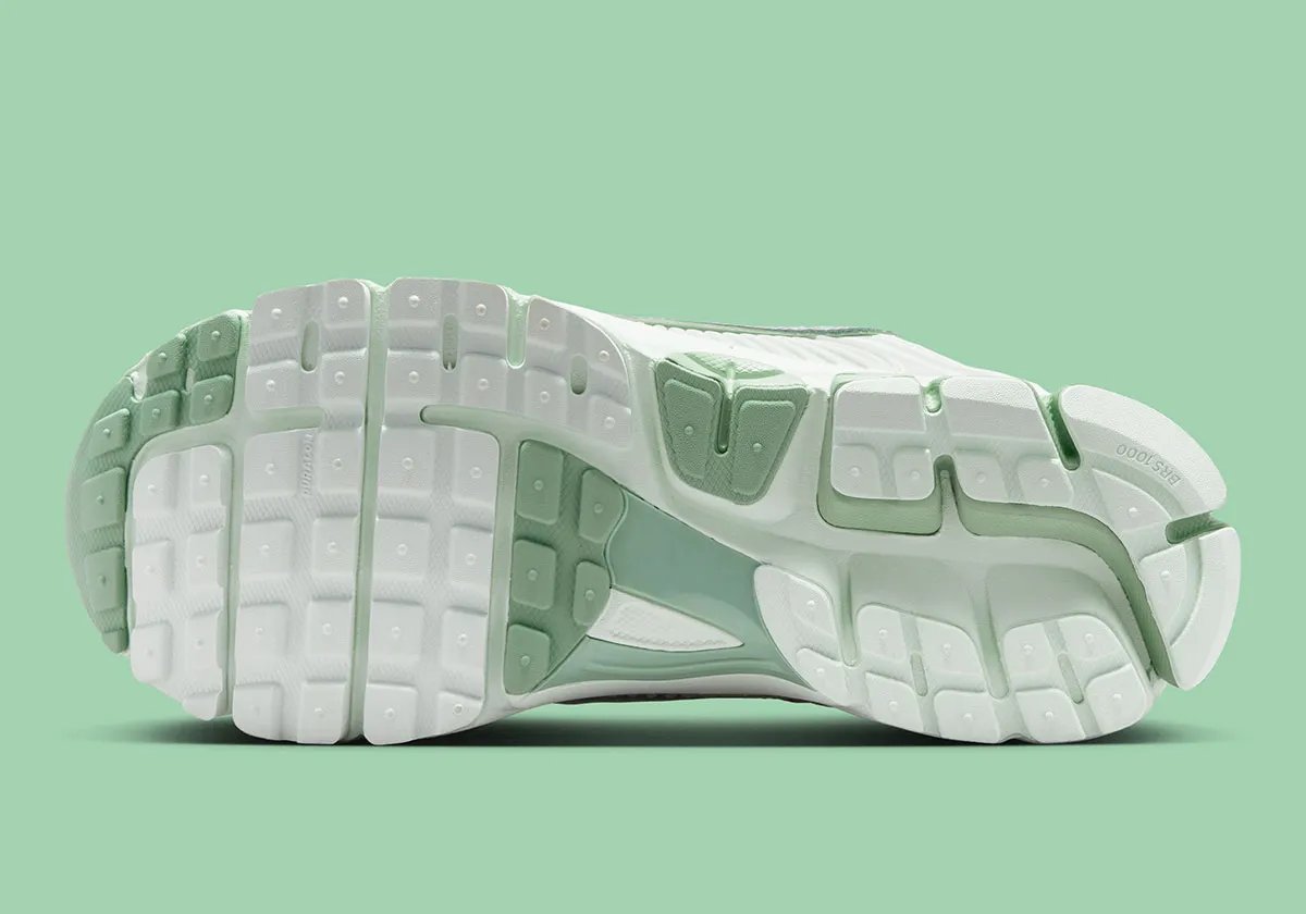 Nike Zoom Vomero 5 in Barely Green with metallic silver chrome accents and dual Swoosh detail - detail view 2