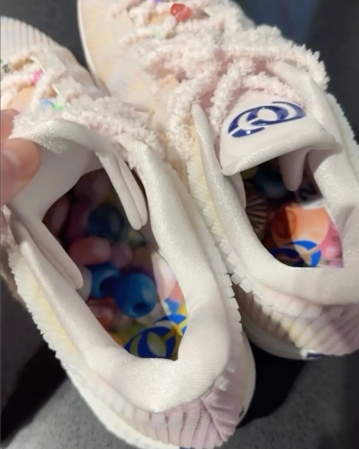 Nike Caitlin 1 'Friendship Bracelet' in Pearl Pink and Racer Blue with iridescent upper and charm-adorned laces, inspired by Taylor Swift's Eras Tour aesthetic - detail view 5
