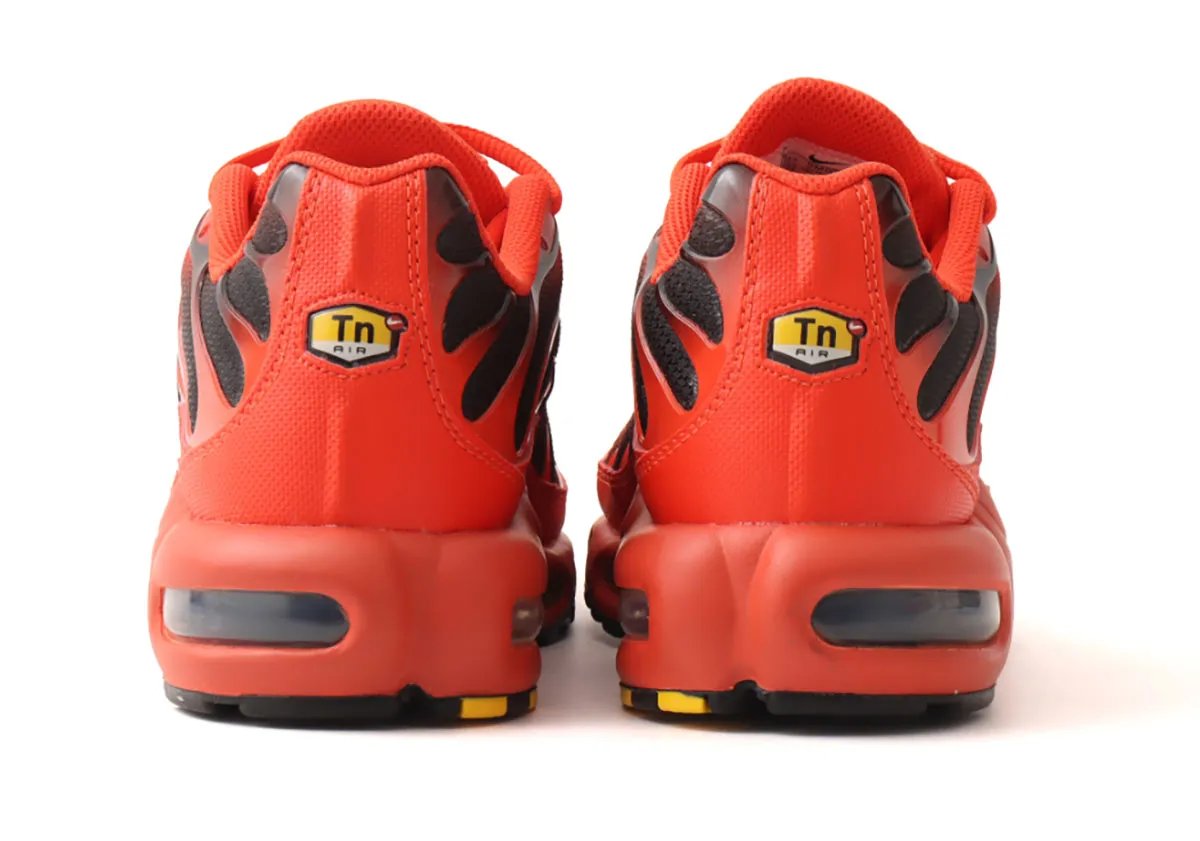 Nike Air Max Plus in red and black colorway, showcasing the silhouette's tubular Air unit and exoskeletal cage design - detail view 2
