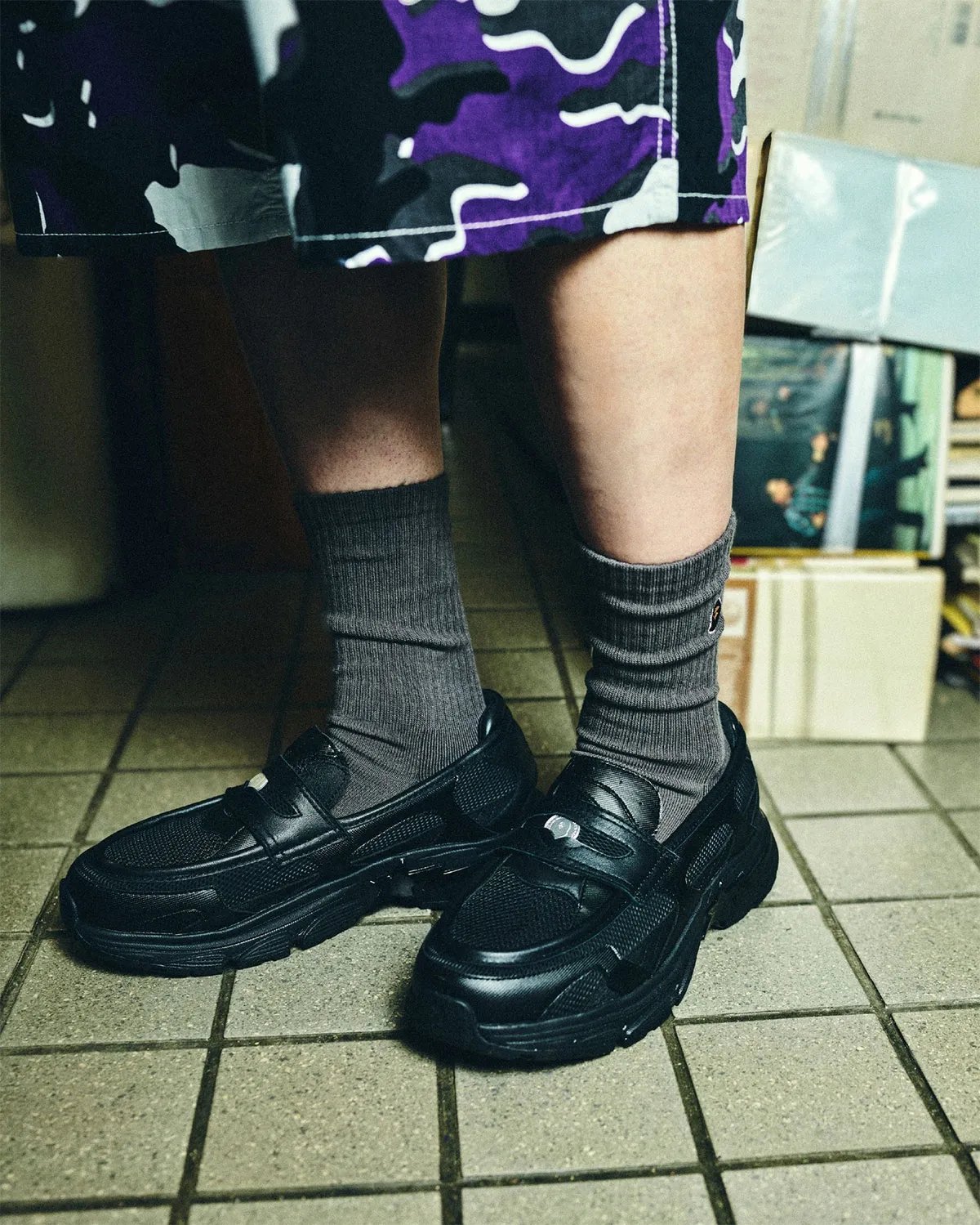 BAPE Loafer STA in light brown colorway, showing laceless loafer upper with textured pocked material and jagged mudguard detailing - detail view 1