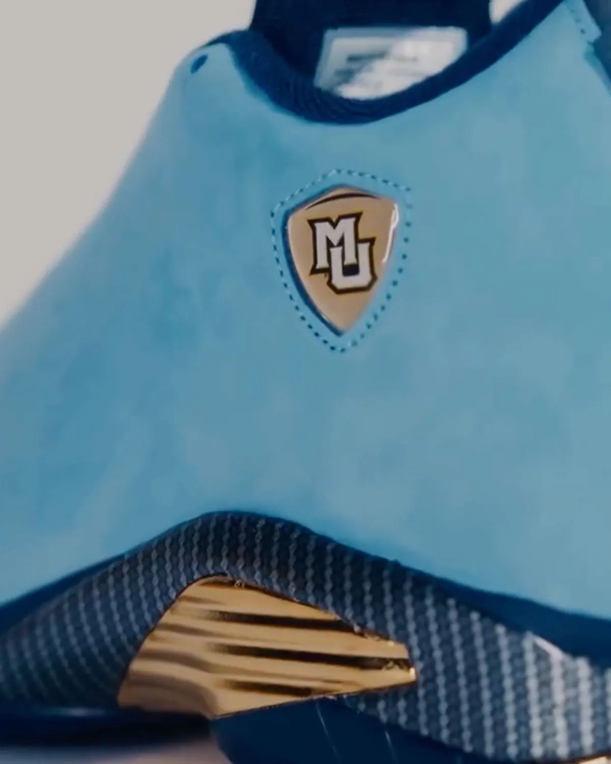 Marquette Air Jordan 14 PE in monochromatic suede with gold midsole vents and carbon fiber overlays - detail view 1